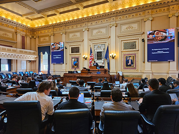 A group of students sitting in the chamber of the Virginia State Capitol