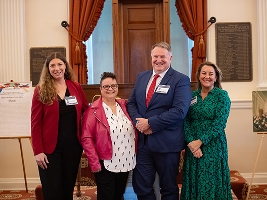 Four VGS program affiliates stand inside the Virginia Capitol